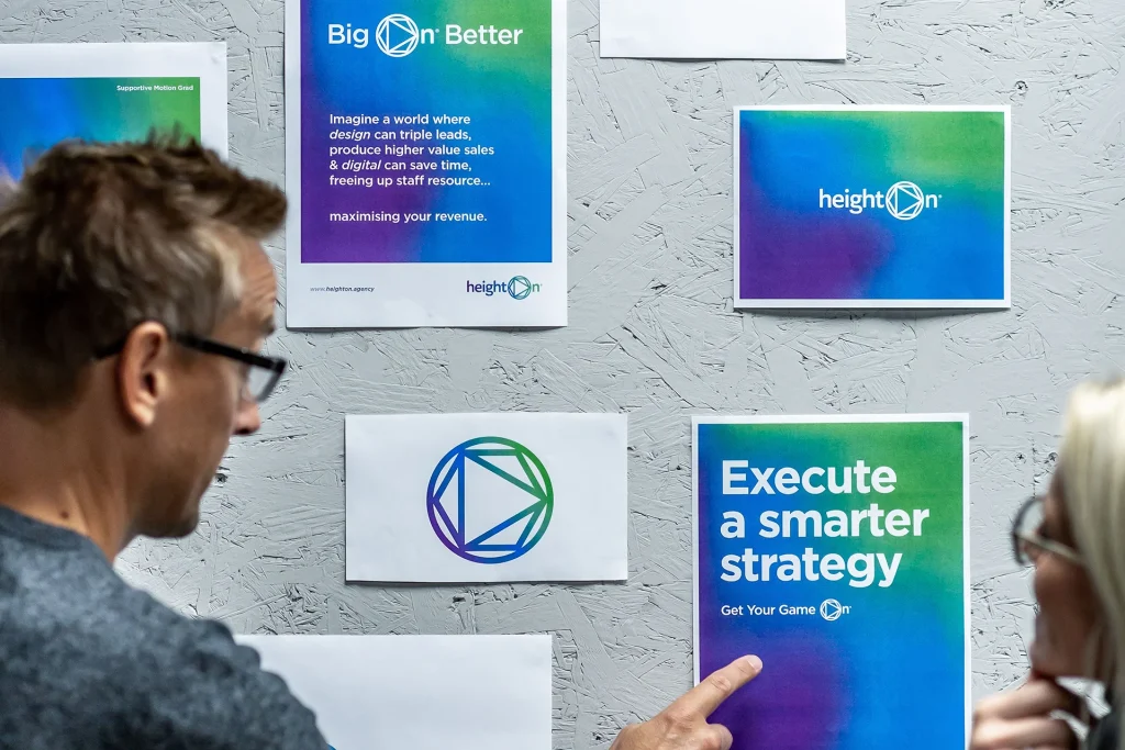 Chris pointing to heighton's new brand identity: "execute a smarter strategy"